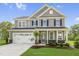 Two-story house with gray siding, white trim, and a two-car garage at 8805 Melvin St # 35, Willow Springs, NC 27592