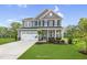 Two-story house with gray siding, white trim, and a two-car garage at 8805 Melvin St # 35, Willow Springs, NC 27592