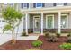 Front entrance with gray door, stone accents, and landscaping at 8805 Melvin St # 35, Willow Springs, NC 27592