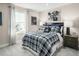 Neat bedroom with a plaid comforter and nightstand at 8829 Tartan Clan Dr, Willow Springs, NC 27592