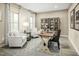 Home office with two armchairs, a wooden desk, and built-in shelves at 8829 Tartan Clan Dr, Willow Springs, NC 27592