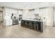 Modern kitchen with white cabinets, stainless steel appliances, and an island at 8829 Tartan Clan Dr, Willow Springs, NC 27592
