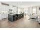 Modern kitchen with white cabinets, stainless steel appliances, and an island at 8829 Tartan Clan Dr, Willow Springs, NC 27592