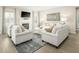 Spacious living room with white sofas and a fireplace at 8829 Tartan Clan Dr, Willow Springs, NC 27592