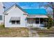 White house with teal roof, front porch, and small lawn at 110 Summit Ave, Raleigh, NC 27603
