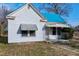 White house with teal roof, front porch, and small lawn at 110 Summit Ave, Raleigh, NC 27603