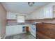 Kitchen with white cabinets and vinyl flooring at 110 Summit Ave, Raleigh, NC 27603