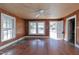 Simple living room with hardwood floors and wood paneling at 110 Summit Ave, Raleigh, NC 27603