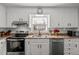 Kitchen with white cabinets, granite counters, and appliances at 1117 Beechwood Dr, Rocky Mount, NC 27803