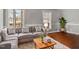 Living room with gray sectional sofa and hardwood floors at 1117 Beechwood Dr, Rocky Mount, NC 27803