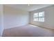 Bright bedroom with carpeted floors and a large window at 1132 Middlecrest Dr, Rocky Mount, NC 27804