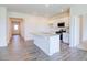 Open concept kitchen with island, hardwood floors, and access to hallway at 1132 Middlecrest Dr, Rocky Mount, NC 27804