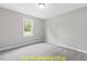 Well-lit bedroom with carpeted floors and window at 116 Mohave Dr, Louisburg, NC 27549