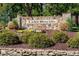 Stone entrance sign for Lake Royale surrounded by flowers and manicured landscaping at 116 Mohave Dr, Louisburg, NC 27549