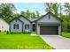 Charming one-story home with gray siding, two-car garage, and manicured lawn at 116 Mohave Dr, Louisburg, NC 27549