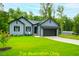 One-story house, gray siding, two-car garage, large yard at 116 Mohave Dr, Louisburg, NC 27549