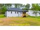 Rear view of house, showcasing deck and yard at 116 Mohave Dr, Louisburg, NC 27549