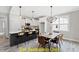 Open kitchen with island, breakfast area, and modern light fixtures at 116 Mohave Dr, Louisburg, NC 27549
