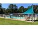 Community swimming pool with shade umbrellas and seating at 116 Mohave Dr, Louisburg, NC 27549