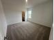 Bedroom featuring carpeted floor with neutral walls and natural light from window at 11826 Salers Loop, Middlesex, NC 27557