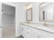 Bright bathroom featuring a double vanity with framed mirrors and neutral color palette at 1246 Jamestowne Dr, Elon, NC 27244