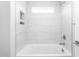 Bright bathroom featuring white tiled walls and a shower/tub combo with window at 1246 Jamestowne Dr, Elon, NC 27244
