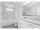Modern bathroom featuring white cabinets, granite counters, and marble-style tiled shower at 1246 Jamestowne Dr, Elon, NC 27244