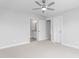 A bright bedroom with neutral walls, carpet floors, ceiling fan, and doorways to other rooms at 1246 Jamestowne Dr, Elon, NC 27244