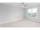 A bedroom featuring neutral walls, carpet floors, a ceiling fan, and a view of the neighborhood at 1246 Jamestowne Dr, Elon, NC 27244