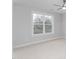 An empty bedroom with neutral walls, carpet floors, a ceiling fan, and a large window at 1246 Jamestowne Dr, Elon, NC 27244
