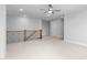 A large bonus room with neutral walls, carpet flooring, ceiling fan, railing, and recessed lighting at 1246 Jamestowne Dr, Elon, NC 27244