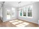 Well-lit dining area featuring many windows and a modern chandelier at 1246 Jamestowne Dr, Elon, NC 27244