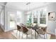 Modern dining area with a chandelier and many windows at 1246 Jamestowne Dr, Elon, NC 27244