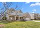 Inviting two-story home with brick and siding, two-car garage, and manicured front yard on a sunny day at 1246 Jamestowne Dr, Elon, NC 27244