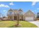 Charming two-story home featuring a brick facade, a two-car garage, and a well-maintained lawn at 1246 Jamestowne Dr, Elon, NC 27244