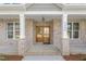 Elegant entryway featuring a stunning wood door and classic brick columns at 1246 Jamestowne Dr, Elon, NC 27244
