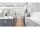 Well-lit kitchen with an island, stainless steel appliances, and stone countertops at 1246 Jamestowne Dr, Elon, NC 27244
