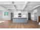 Modern kitchen with a large center island, white cabinets, and stainless steel appliances at 1246 Jamestowne Dr, Elon, NC 27244