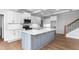 Beautiful kitchen featuring an island with a stone countertop and state-of-the-art appliances at 1246 Jamestowne Dr, Elon, NC 27244