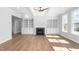Bright living area featuring a fireplace, built-in shelves, and hardwood floors at 1246 Jamestowne Dr, Elon, NC 27244