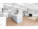 Open concept kitchen and living room featuring modern appliances and a cozy fireplace at 1246 Jamestowne Dr, Elon, NC 27244