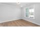 Bright room with window, hardwood floors, and modern lighting fixtures at 1246 Jamestowne Dr, Elon, NC 27244