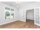 Bright room with window, hardwood floors, open entrance, and modern lighting fixtures at 1246 Jamestowne Dr, Elon, NC 27244