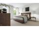 Spacious bedroom with a king-size bed, window, and wood accents at 1264 Hardin Hill Ln, Knightdale, NC 27545