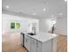 Modern kitchen featuring an island, stainless steel appliances, and sleek white cabinetry at 1264 Hardin Hill Ln, Knightdale, NC 27545