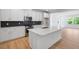 Modern kitchen featuring an island, stainless steel appliances, and sleek white cabinetry at 1264 Hardin Hill Ln, Knightdale, NC 27545