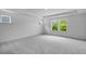 Spacious bedroom with plush carpeting and a large window offering a serene view of the outdoors at 1264 Hardin Hill Ln, Knightdale, NC 27545