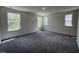 Spacious carpeted bedroom has an abundance of natural light from multiple windows at 136 Parker Ln, Mebane, NC 27302