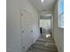 Bright hallway with wood-look floors, leading to an open-concept living space filled with natural light at 136 Parker Ln, Mebane, NC 27302