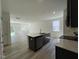 Stylish kitchen features a large island, modern cabinetry, and stainless steel appliances at 136 Parker Ln, Mebane, NC 27302